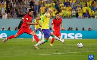 韩国队守门员金承奎（右二）与巴西队球员布雷默在比赛中拼抢
